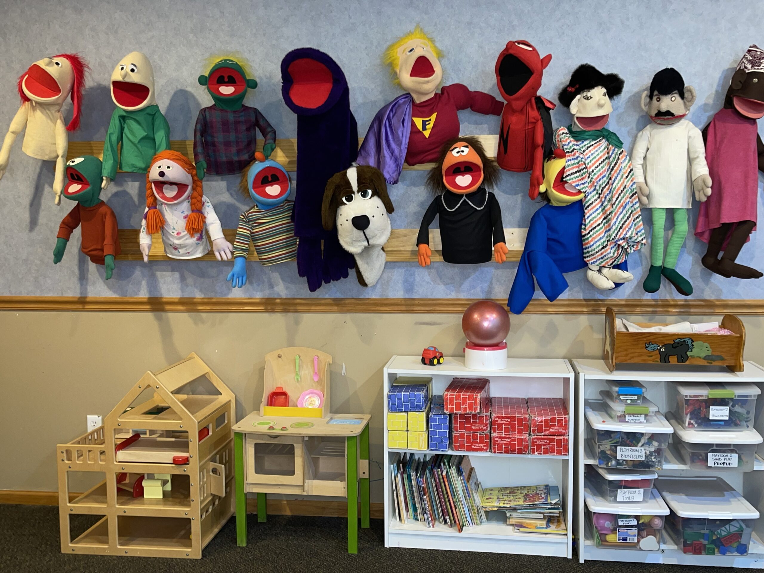 Child therapy room at Secure Base Counseling Center in Minnesota with toys, puppets, and other play items.